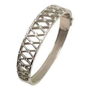 Angled view of Diamond and Platinum bangle, with 'X' shaped lattice, incorporating diamonds at each corner. A lovely jewellery item available to buy online from Plaza Jewellery